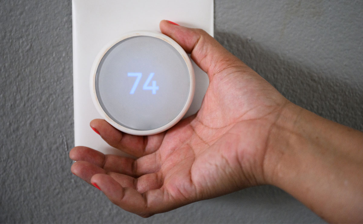 hand adjusting thermostat knob
